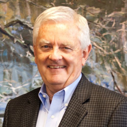 headshot of The Midland Group's CEO, Gordan smiling wearing a suit